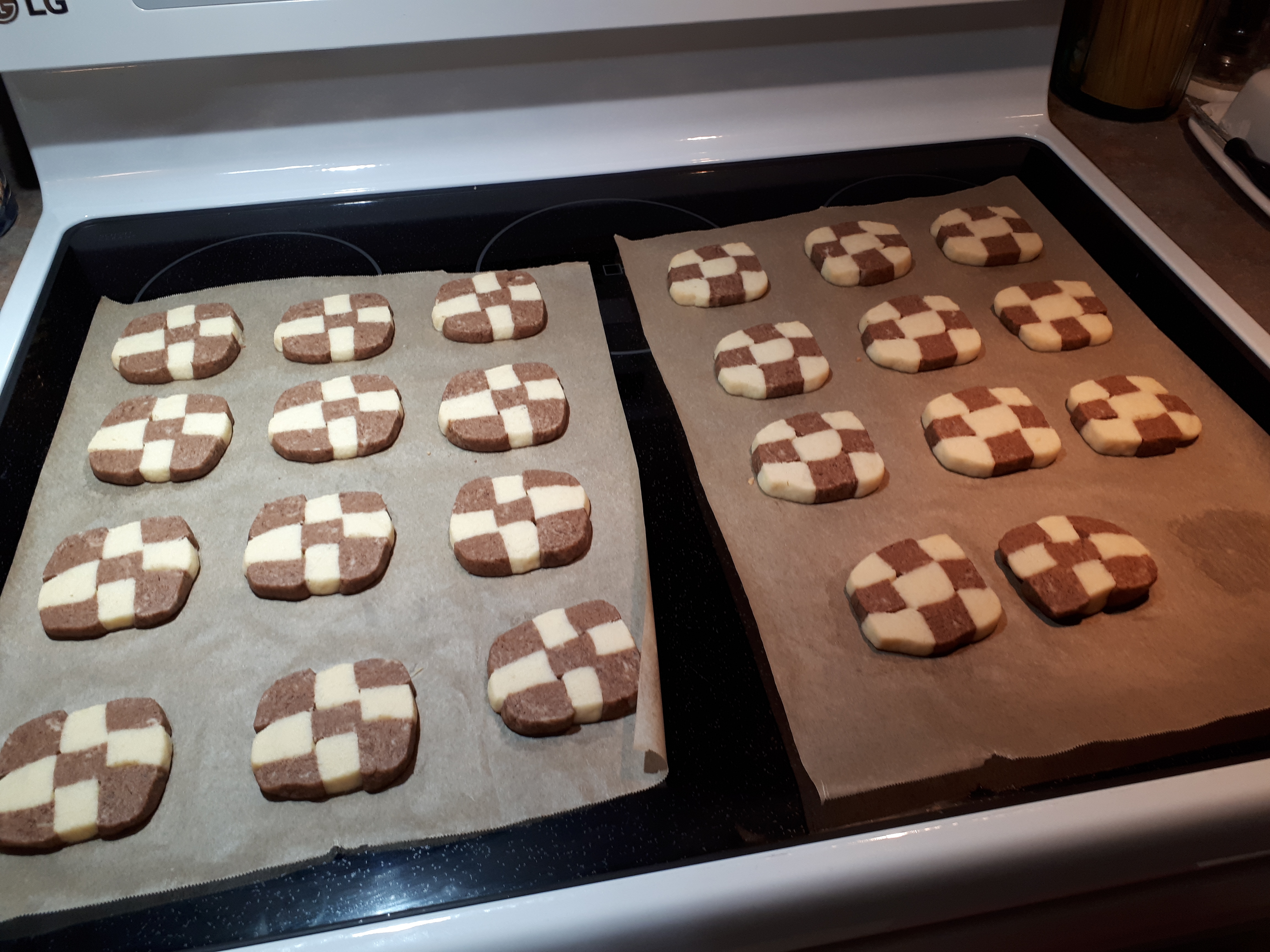 Two trays of chocolate and vanilla checkerboard icebox cookies.